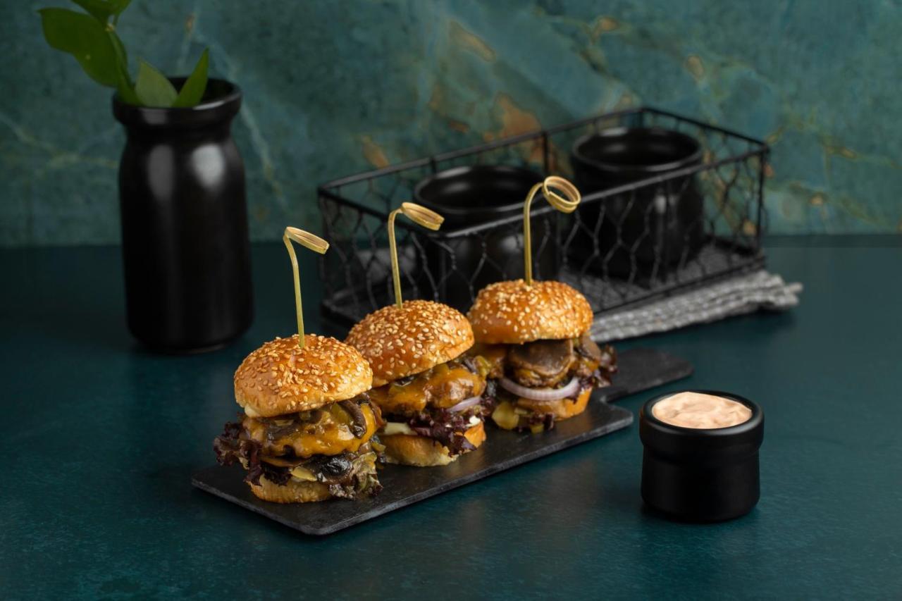 Citadines Abha Aparthotel Bagian luar foto A trio of sliders
